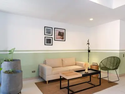 a living room with a couch and a table at NOK Spectacular 3 BR w Balcony in Laureles Medellin in Medellín