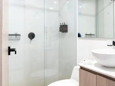 a bathroom with a shower and a toilet and a sink at NOK Spectacular 3 BR w Balcony in Laureles Medellin in Medellín