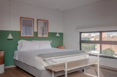 a bedroom with a large bed and a window at NOK Stylish Studio w Balcony in Laureles Medellin in Medellín