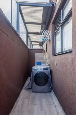a washing machine sitting in the corner of a building at NOK Stylish Studio w Balcony in Laureles Medellin in Medellín