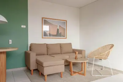 a living room with a couch and a chair at NOK Stylish Studio w Balcony in Laureles Medellin in Medellín