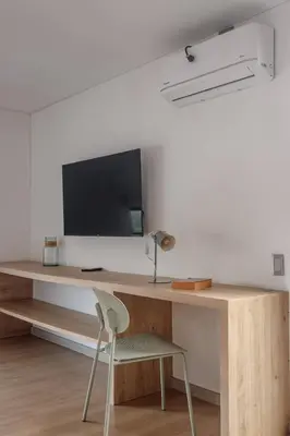 a room with a desk with a tv and a chair at NOK Stylish Studio w Balcony in Laureles Medellin in Medellín