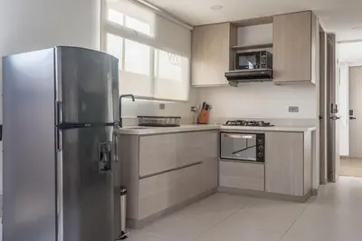 a kitchen with a stainless steel refrigerator at NOK Stylish Studio w Balcony in Laureles Medellin in Medellín