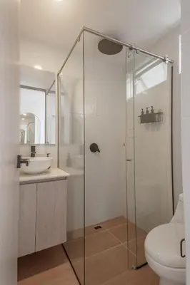 a bathroom with a glass shower and a sink at NOK Stylish Studio w Balcony in Laureles Medellin in Medellín