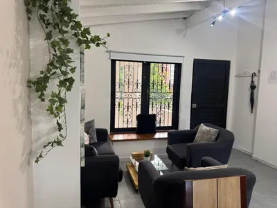 a living room with two couches and a window at Cozy and Central Apartment in Laureles in Medellín