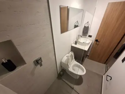 a bathroom with a toilet and a sink at Hotel La Casona Estadio in Medellín