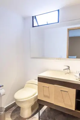a bathroom with a toilet and a sink at Hotel Laureles Loft in Medellín