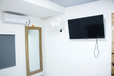 a living room with a tv and a mirror at Pura Vida in Quibdó