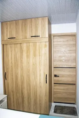 two wooden cabinets in a room with a ceiling at Pura Vida in Quibdó