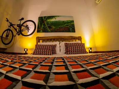 a bedroom with a bed with a bike hanging on the wall at Hotel Brisas La Gaviota Mariquit-Tolima in Mariquita