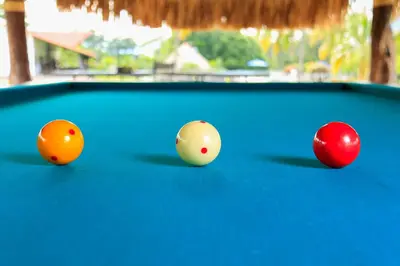 three billiard balls on a pool table at Hotel Brisas La Gaviota Mariquit-Tolima in Mariquita