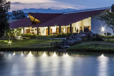 a house with a river in front of it at Hotel Brisas La Gaviota Mariquit-Tolima in Mariquita