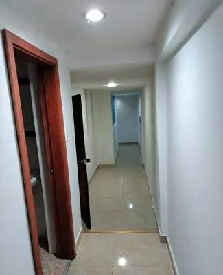 an empty hallway with a hallway leading to a room at Rento apartamento por días in Manizales