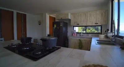 a kitchen with a stove and a refrigerator at Finca Mirador de Santágueda in Palestina