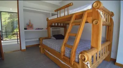 a bedroom with two bunk beds with a ladder at Finca Mirador de Santágueda in Palestina