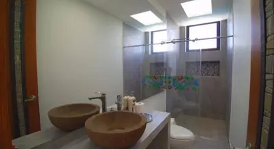 a bathroom with two wooden sinks and a shower at Finca Mirador de Santágueda in Palestina