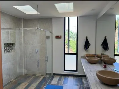 a bathroom with three sinks and a shower at Finca Mirador de Santágueda in Palestina