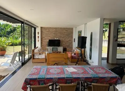 a dining room with a table and a living room at Finca Mirador de Santágueda in Palestina