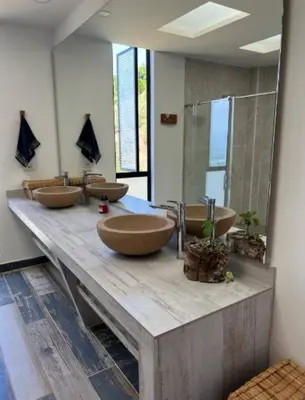 a bathroom with four sinks on a wooden counter at Finca Mirador de Santágueda in Palestina