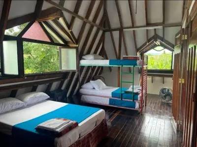 a room with two beds and two windows at Finca El Refugio Familiar in Manizales