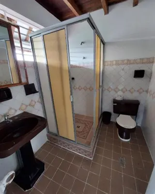 a bathroom with a shower and a sink and a toilet at Finca El Refugio Familiar in Manizales