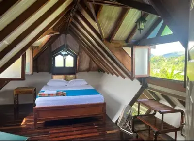 a bedroom with a bed in a attic at Finca El Refugio Familiar in Manizales
