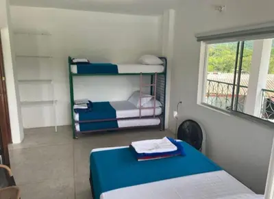 a room with two bunk beds and a window at Finca El Refugio Familiar in Manizales