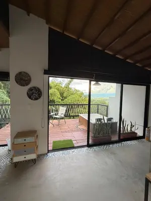 a room with a large sliding glass door with a patio at Cabaña Hogar del Bosque in Palestina