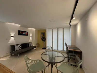 a living room with a glass table and chairs at Relaxing appartement in the middle of Poblado in Medellín