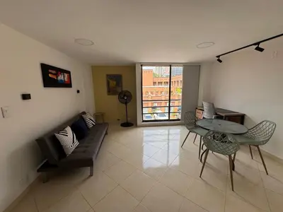 a living room with a couch and a table and chairs at Relaxing appartement in the middle of Poblado in Medellín