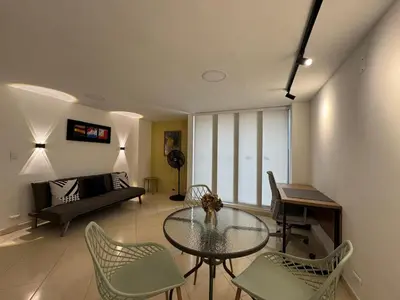 a living room with a glass table and chairs at Relaxing appartement in the middle of Poblado in Medellín