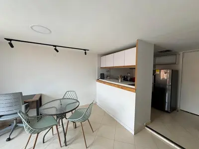 a kitchen and dining room with a table and chairs at Relaxing appartement in the middle of Poblado in Medellín