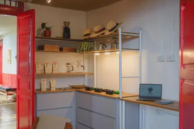 a kitchen with a counter with a laptop on it at Hacienda Santa Bárbara Coffee Farm in La Linda