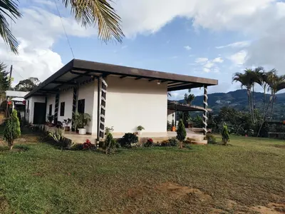 a white house with a black roof at Finca Tasnia in Chiquinquirá