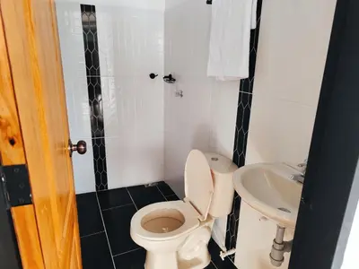 a bathroom with a toilet and a sink at Finca Tasnia in Chiquinquirá
