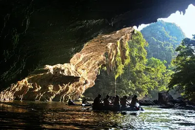 a group of people in a boat in a cave at Rio Claro Reserva Natural in San Francisco