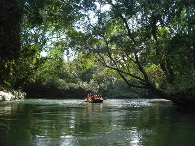 a group of people in a boat on a river at Rio Claro Reserva Natural in San Francisco