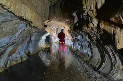a person standing in the middle of a cave at Rio Claro Reserva Natural in San Francisco