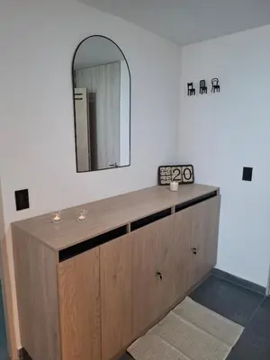 a bathroom with a wooden vanity with a mirror at Modern apartment in front of the Autonoma University - Manizales in Manizales