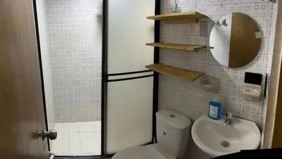 a small bathroom with a toilet and a sink at Plaza de Toros & Centro Ubicación Ideal in Manizales