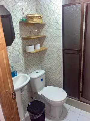 a bathroom with a toilet and a sink at Plaza de Toros & Centro Ubicación Ideal in Manizales