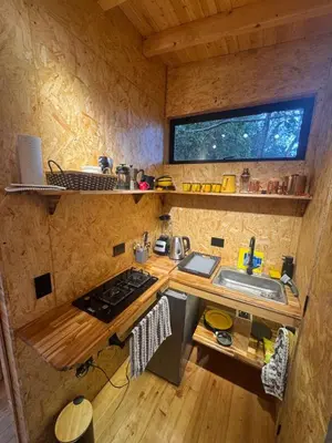 a small kitchen with a sink and a stove at Boheme Cabin in Medellín