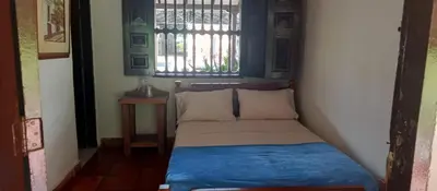 a small bed in a room with a window at Finca Hotel El Juncal in Venecia