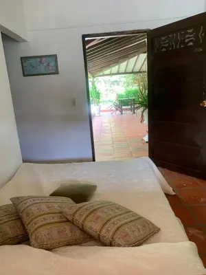 a bed with pillows on it in a room at Finca Hotel El Juncal in Venecia