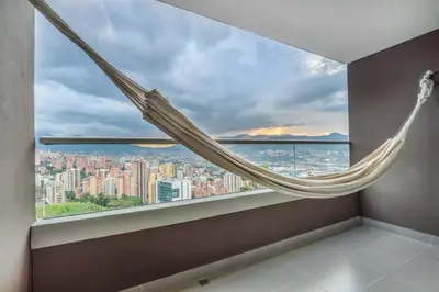 a hammock in a room with a large window at PANORÁMIKA - Unique 1BD 1 and half Bath Best views Long term in Medellín
