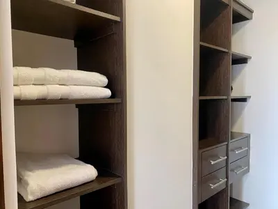 a closet with wooden shelves and white towels at PANORÁMIKA - Unique 1BD 1 and half Bath Best views Long term in Medellín