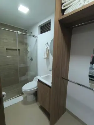 a bathroom with a toilet and a sink and a shower at Acogedor aparta-loft con jacuzzi in Medellín