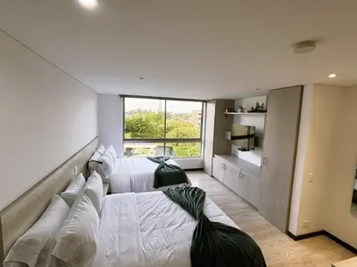 a bedroom with two beds and a large window at Private 1BR 2Bed AC Suite | Llanogrande Airport in Rionegro