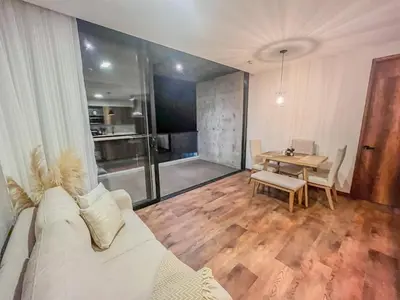 a living room with a white couch and a table at Modern 2BR 3Bed Country Suite | El Retiro, Ant in El Retiro