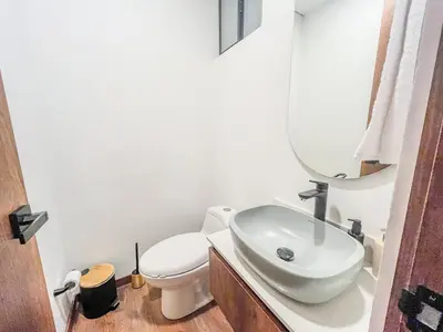 a bathroom with a sink and a toilet and a mirror at Modern 2BR 3Bed Country Suite | El Retiro, Ant in El Retiro